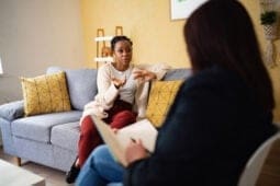 woman on couch talking to therapist